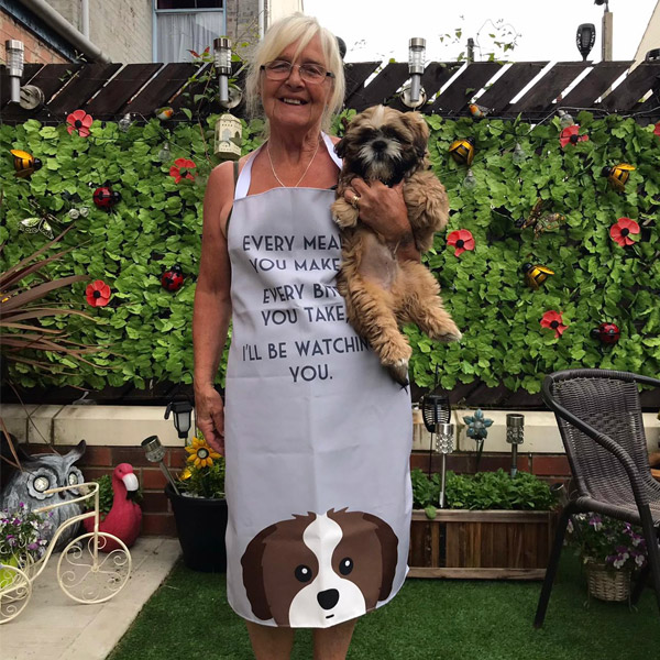 A lady wearing a personalised apron featuring her dog
