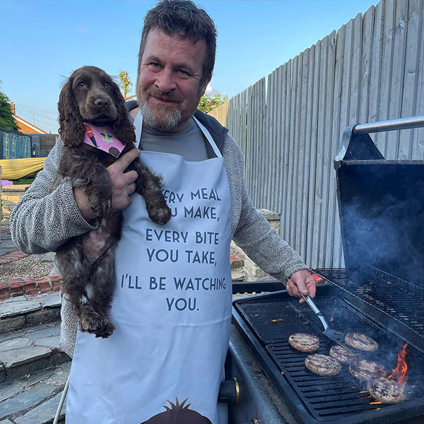 Man wearing Personalised Apron holding his dog Brandy