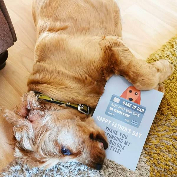 terrier holding his 'bank of dad' fathers day greeting card